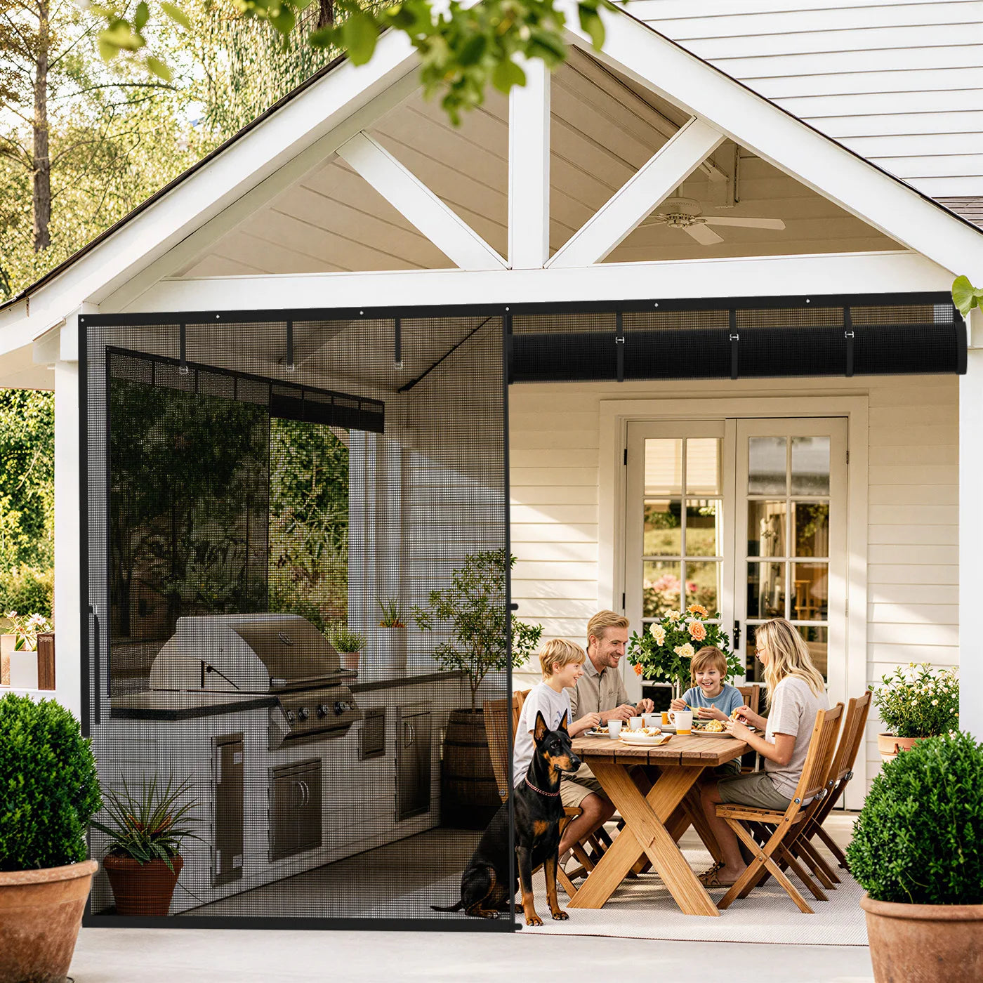 A family having lunch at a patio table behind a magnetic screen door with a roll-up feature.